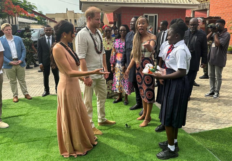 Britain's Prince Harry, Duke of Sussex and his wife Meghan, Duchess of Sussex, arrive to meet  students at the Lightway Academy up on their arrival in Abuja, Nigeria (REUTERS)