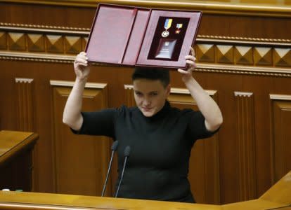 Ukrainian parliamentary deputy Nadiya Savchenko shows her Star of the Hero of Ukraine during a parliament session in Kiev, Ukraine March 22, 2018. REUTERS/Valentyn Ogirenko