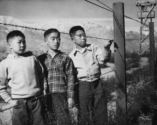 Boys Behind Barbed Wire (Norito Takamoto, Albert Masaichi, and Hisashi Sansui), 1944. <br /><br />Photos in this series courtesy of Photographic Traveling Exhibitions; the County of Inyo, Eastern California Museum; and Alan Miyatake.