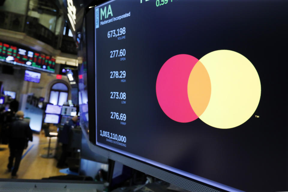 Mastercard logo appears above a trading post on the floor of the New York Stock Exchange. Photo: Richard Drew/AP