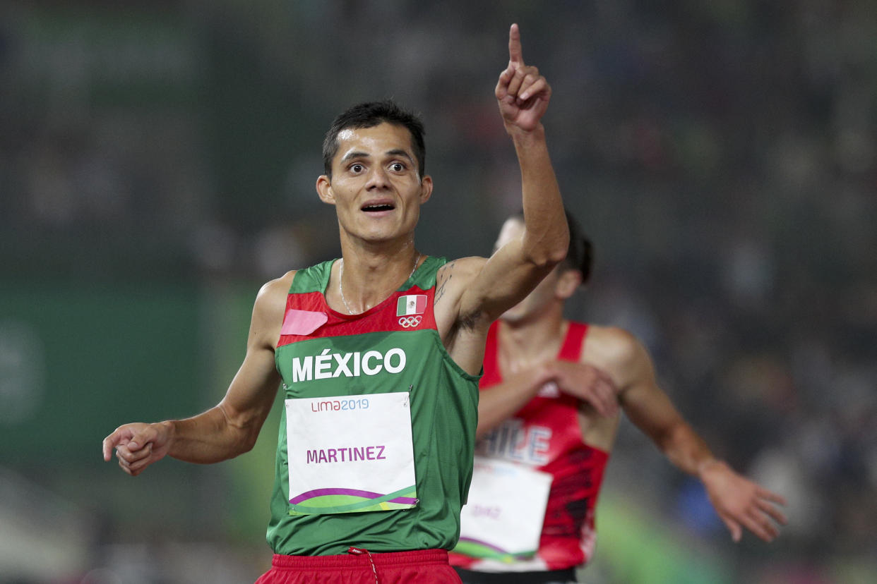 Fernando Martinez of Mexico celebrates winning the gold medal in the men's 5000m during the athletics final at the Pan American Games in Lima, Peru, Tuesday, Aug. 6, 2019. (AP Photo/Martin Mejia)