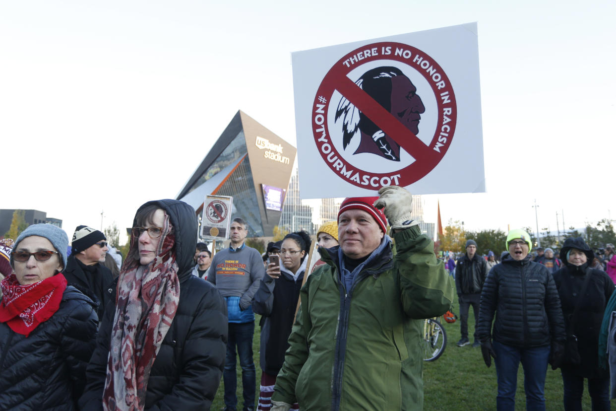 Native American leaders protest outside U.S. Bank Stadium before an NFL football game between the Minnesota Vikings and the Washington Redskins, Thursday, Oct. 24, 2019, in Minneapolis. The group was protesting to urge the visiting Washington team to retire the Redskins team name and mascot. (AP Photo/Bruce Kluckhohn)