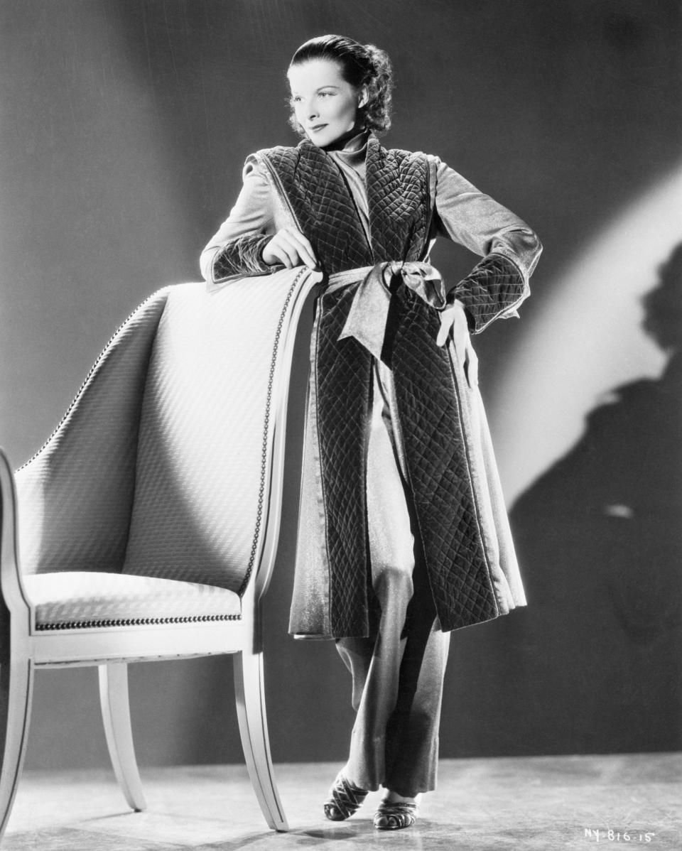 Movie star Katharine Hepburn models a gold robe and pajama set, circa 1935.&nbsp;
