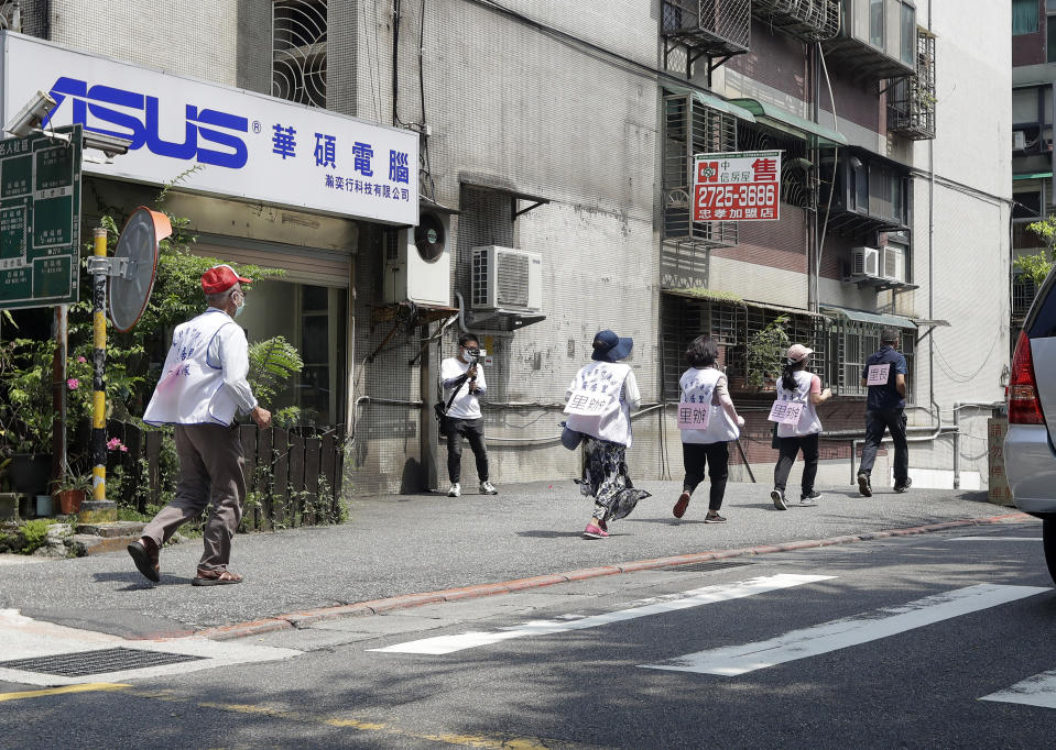 Taiwanese people run to a basement shelter during the Wanan air raid drill, in Taipei, Taiwan, Monday, July 25, 2022. Taiwan’s capital staged air raid drills Monday and its military mobilized for routine defense exercises, coinciding with concerns over a forceful Chinese response to a possible visit to the island by U.S. Speaker of the House Nancy Pelosi. (AP Photo/Chiang Ying-ying)