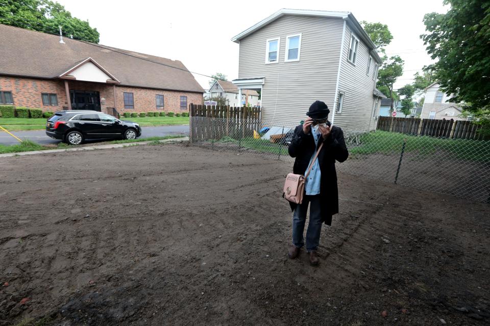 Veronica Hemphill-Nichols, 57, cries as she stands on an empty lot where her home of 16 years once stood in the Fruit Belt neighborhood of Buffalo, N.Y. May 16, 2022.