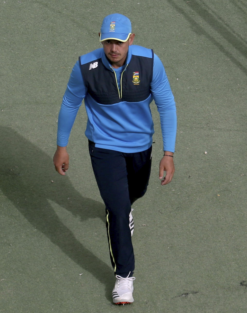 South Africa cricket team's skipper Quinton de Kock walks back from the field after attending a practice session at the National Cricket Stadium, in Karachi, Pakistan, Saturday, Jan. 23, 2021. South Africa, which arrived in the southern port city of Karachi for the first time in nearly 14 years, will play the first test match against Pakistan starting on Jan. 26. (AP Photo/Fareed Khan)