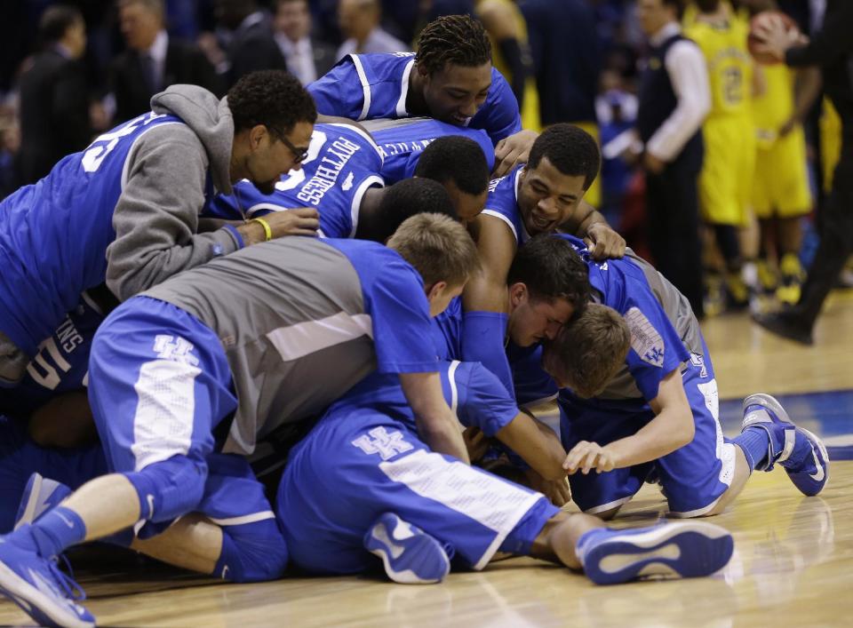 Kentucky players celebrate after an NCAA Midwest Regional final college basketball tournament game against Michigan Sunday, March 30, 2014, in Indianapolis. Kentucky won 75-72 to advance to the Final Four. (AP Photo/David J. Phillip)