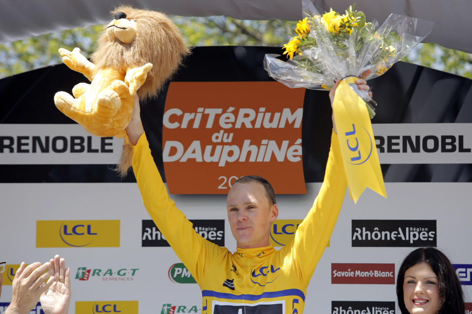 FILE - In this Friday, June 7, 2013 file photo, Britain's Christopher Froome of the Sky Procycling team celebrates with the yellow jersey on the podium after the sixth stage of the 65th Dauphine cycling race between La Lechere and Grenoble, French Alps. Four-time Tour de France winner Chris Froome will miss this year’s race after a “bad crash” in training on Wednesday June 12, 2019. Team INEOS leader Dave Brailsford said Froome sustained a suspected fractured femur in a 60 kph (40 mph) crash. (AP Photo/Laurent Cipriani, File)