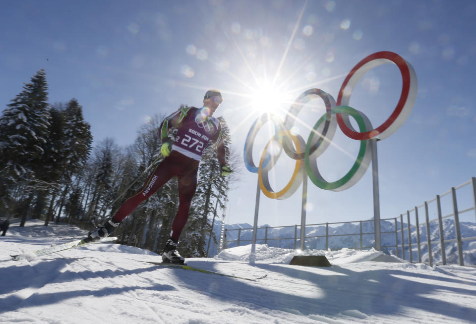 Hungary's Milan Szabo passes by Olympic rings as he trains in the Cross Country stadium of the 2014 Winter Olympics, Tuesday, Feb. 4, 2014, in Krasnaya Polyana, Russia. (AP Photo/Dmitry Lovetsky)