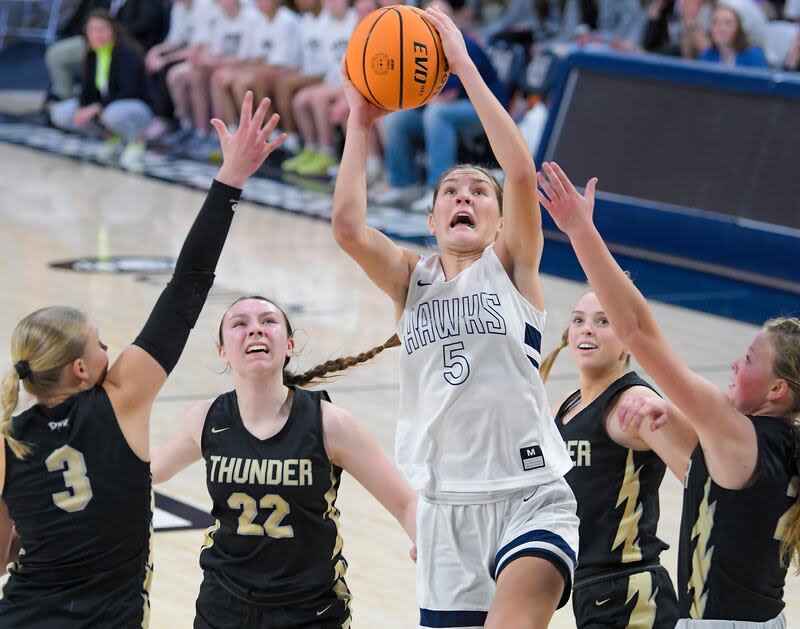 Ridgeline's Emilee Skinner (5) shoots the ball as Desert Hills' Tess Peterson (3), Ashtin Hansen (22), Kaitlyn Andrus, and Brynlee Mortenson defend during a quarterfinal game in the Utah 4A girls basketball tournament on Thursday in Logan. | Eli Lucero, Herald Journal