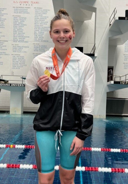 Bloomington North's Ashley Freel holds her sixth place medal from the 100 backstroke at the IHSAA state girls' swimming meet on Saturday, Feb. 11, 2023.