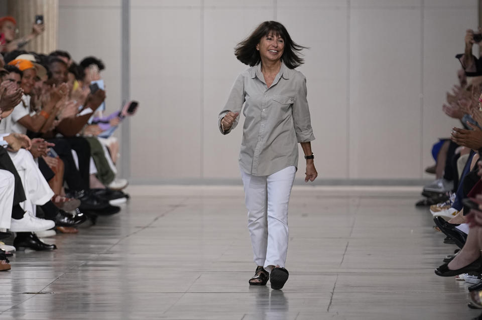 Designer Veronique Nichanian accepts applause after the conclusion of the Hermes Menswear Spring/Summer 2024 fashion collection presented in Paris, Saturday, June 24, 2023. (AP Photo/Michel Euler)