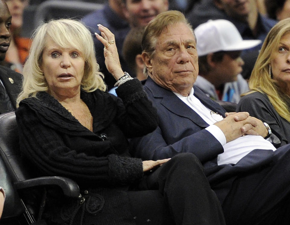 FILE - In this Nov. 12, 2010, file photo, Los Angeles Clippers owner Donald T. Sterling, right, sits with his wife Rochelle during the Clippers NBA basketball game against the Detroit Pistons in Los Angeles. An attorney representing the estranged wife of Clippers owner Donald Sterling said Thursday, May 8, 2014, that she will fight to retain her 50 percent ownership stake in the team. (AP Photo/Mark J. Terrill, File)