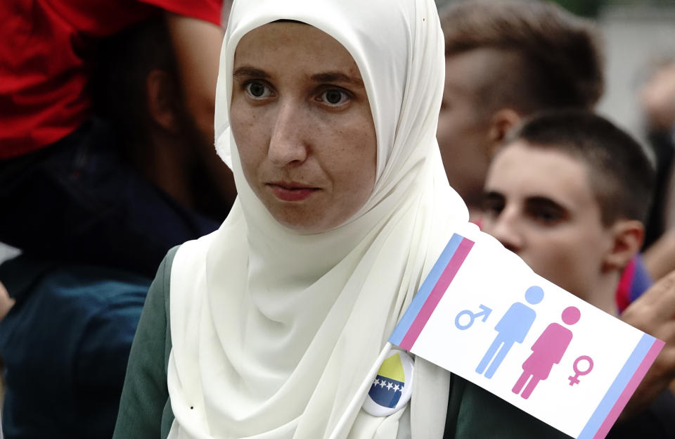 A woman holds a banner as she takes part in what was said was a gathering designed to promote traditional family values in Sarajevo, Bosnia, Saturday, Sept. 7, 2019. Several hundred people have marched in Bosnia's capital Sarajevo to express their disapproval of the Balkan country's first ever LGBT pride parade scheduled for Sunday. (AP Photo/Eldar Emric)