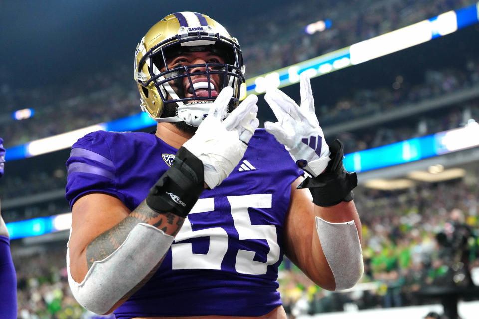 Dec 1, 2023; Las Vegas, NV, USA; Washington Huskies offensive lineman Troy Fautanu (55) celebrates after the Huskies scored against the Oregon Ducks during the first quarter at Allegiant Stadium. Mandatory Credit: Stephen R. Sylvanie-USA TODAY Sports