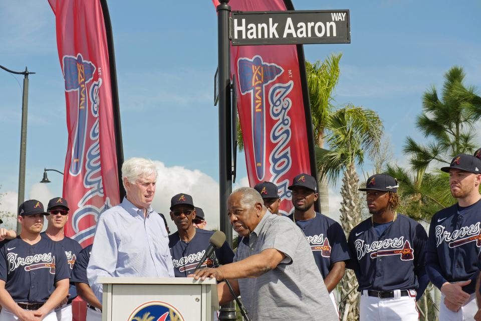 Atlanta Braves Hall of Famer Hank Aaron, right, addresses the crowd Tuesday, Feb. 18, 2020, along with Braves Board Chairman Terry McGuirk, after the unveiling of Hank Aaron Way at CoolToday Park in North Port.