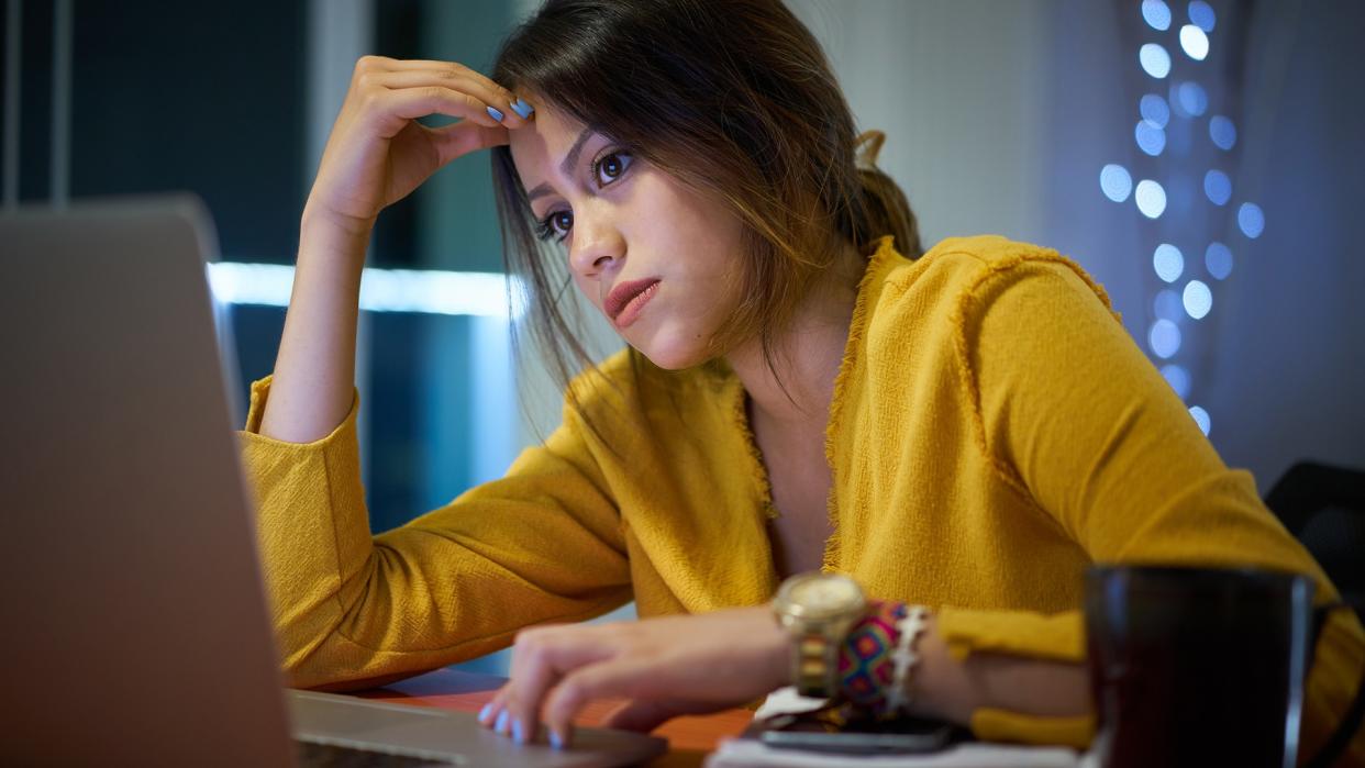 Young woman with laptop computer for homework.