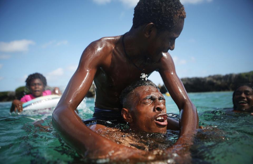 People swim at Eton Beach on November 30, 2019 in Efate, Vanuatu.