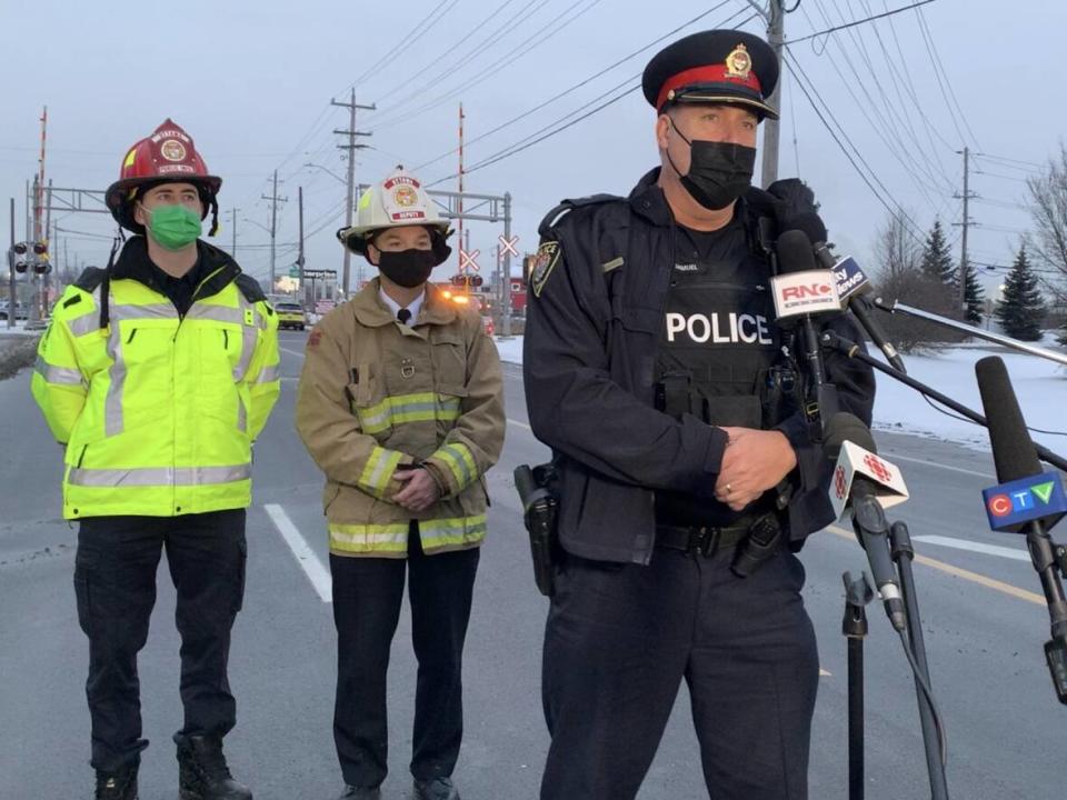 An Ottawa Police Service spokesperson addresses media near the site of the Eastway Tank explosion on the evening of the blast on Jan. 13, 2022.  (Guy Quenneville/CBC - image credit)
