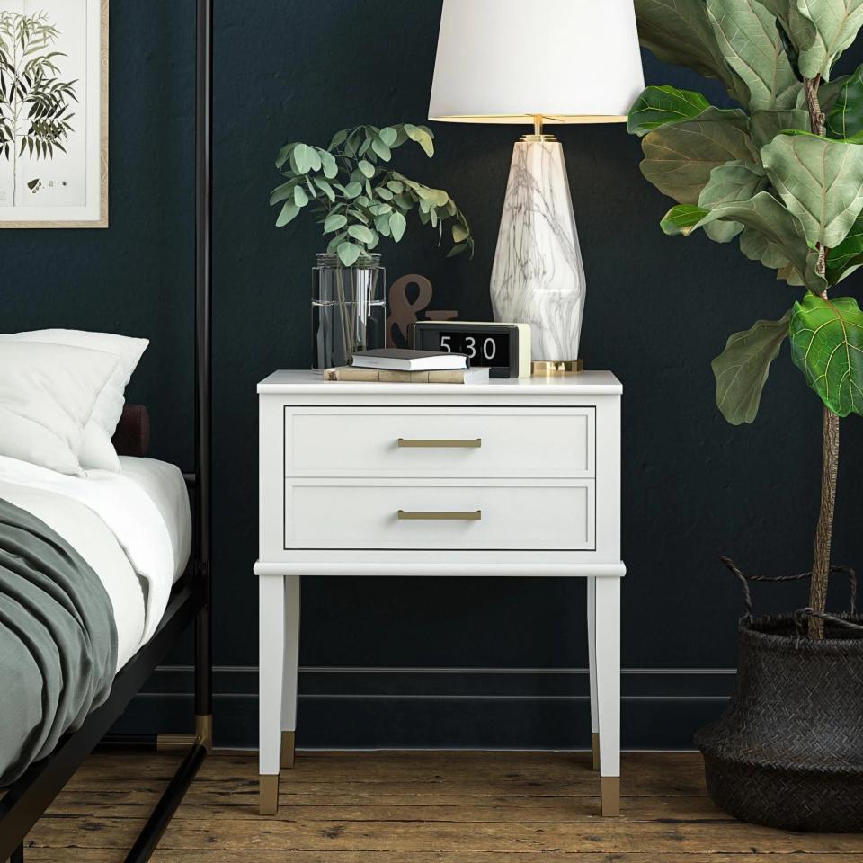 The nightstand in white with brass finishes