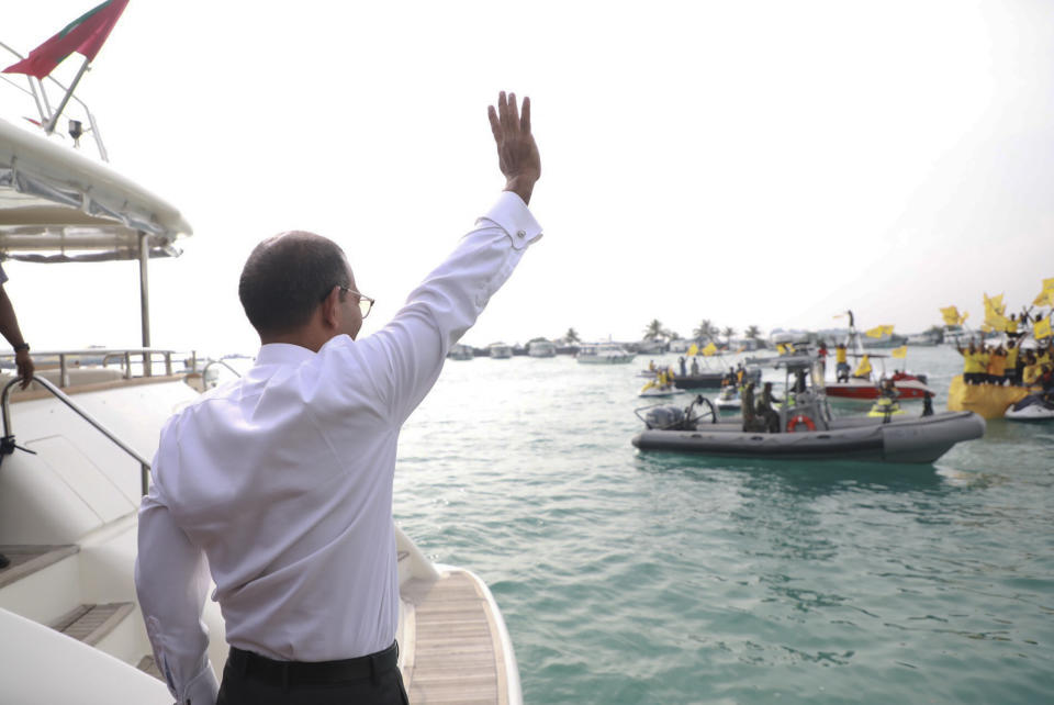 Maldives’ former president Mohamed Nasheed, waves before he heads on a launch to the capital to meet the public after his arrival in Maldives, Thursday, Nov.1, 2018. Nasheed, the first democratically elected president of the Maldives returned home Thursday after more than two years in exile to escape a long prison term. (AP Photo/Mohamed Sharuhaan)