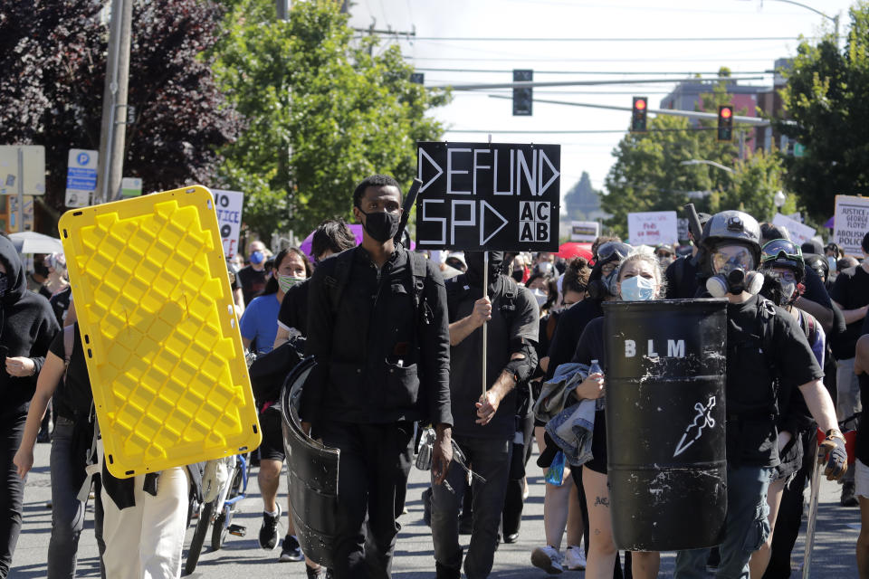 Protesters march near the King County Juvenile Detention Center, Saturday, July 25, 2020, in Seattle in support of Black Lives Matter and against police brutality and racial injustice. (AP Photo/Ted S. Warren)