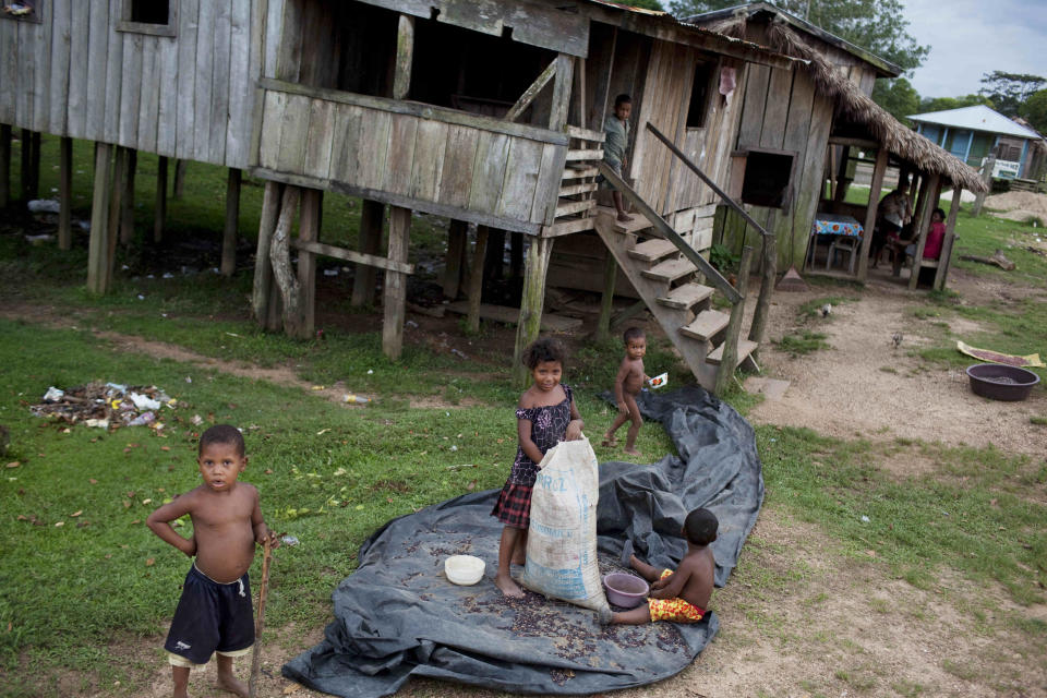 Children play outside their houses in the Paptalaya pier, where helicopters of a joint Honduran-U.S. drug raid landed last Friday, in Ahuas, Mosquitia region, Honduras, Monday, May 21, 2012. On Friday May 11, a helicopter mission with advisers from the DEA, appears to have mistakenly targeted civilians in the remote jungle area, killing four riverboat passengers and injuring four others. Later, according to villagers, Honduran police narcotics forces and men speaking English spent hours searching the small town of Ahuas for a suspected drug trafficker.(AP Photo/Rodrigo Abd)
