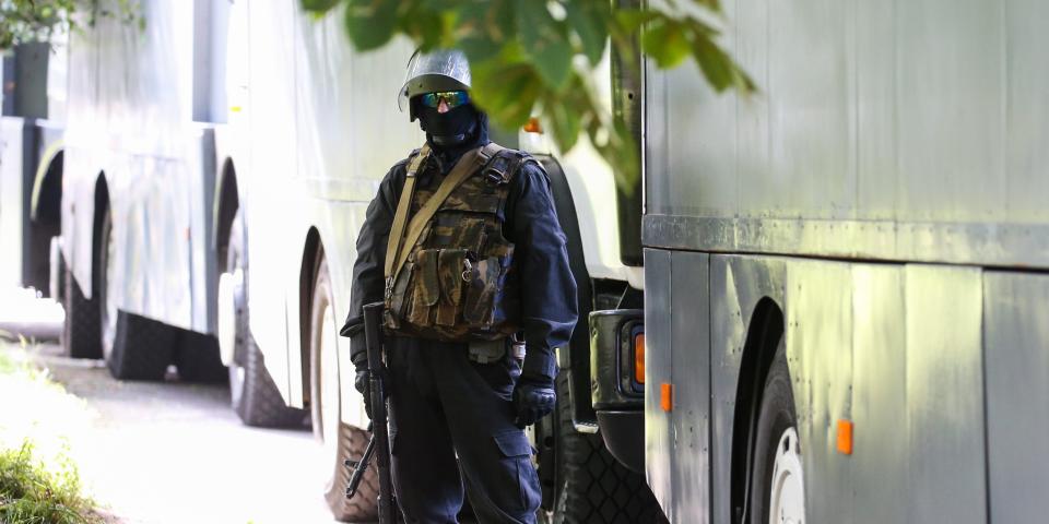 MINSK, BELARUS - AUGUST 13, 2020: A law enforcement officer guards an area outside a temporary detention facility where detained participants in mass protests against the results of the 2020 Belarusian presidential election are kept. Natalia Fedosenko/TASS (Photo by Natalia Fedosenko\TASS via Getty Images)