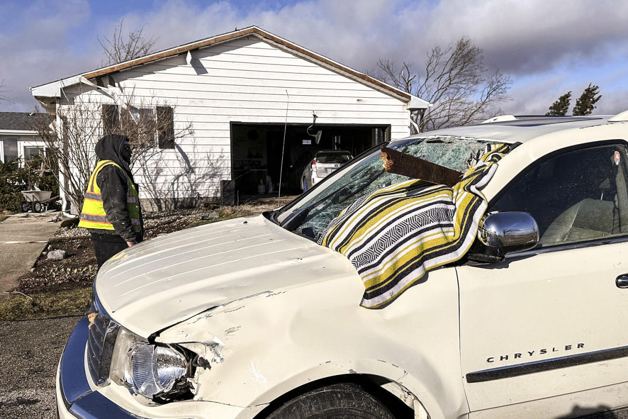 Image: A chunk of wood is impaled in Dan Wagner's SUV outside his home (Todd Richmond / AP)