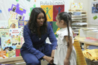 Former first lady Michelle Obama speaks with a school girl during a surprise appearance at Para Los Niños on Thursday, Nov. 15, 2018, in Los Angeles. (Photo by Willy Sanjuan/Invision/AP)