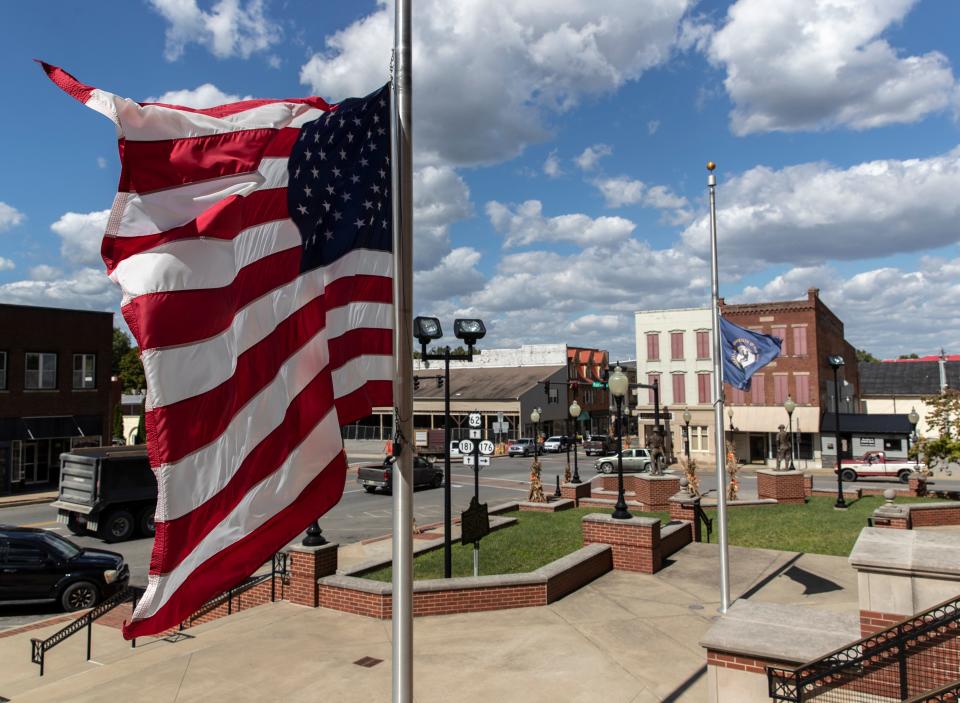 The American flag flies in front of the Muhlenberg County courthouse in Greenville, Kentucky. The county, made famous in John Prine's song, Paradise, is suffering from the decline in coal. Oct. 1, 2020