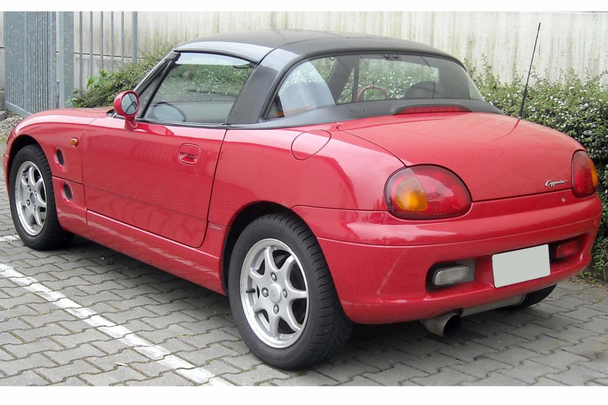 Red Suzuki Cappuccino parked in a parking space