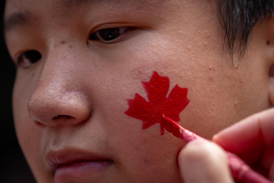 Photo Gallery: Canadians in a sea of red celebrate Canada Day at various events in cities and towns across the country.