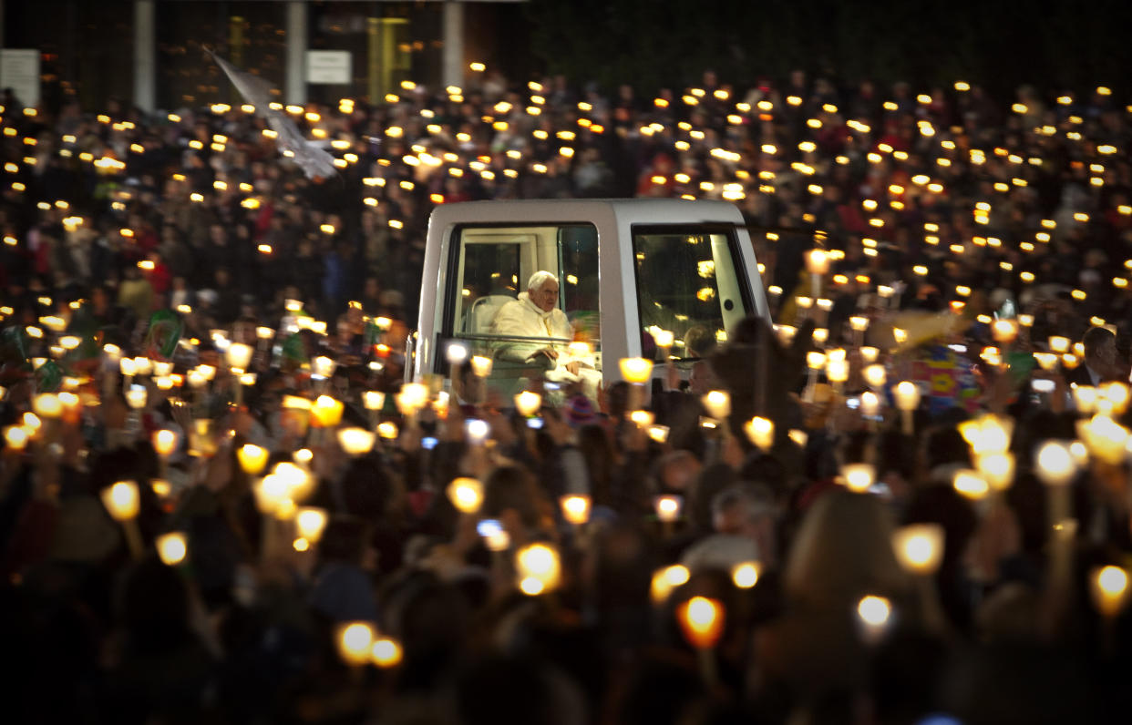 Pope Benedict XVI rides in the popemobile.