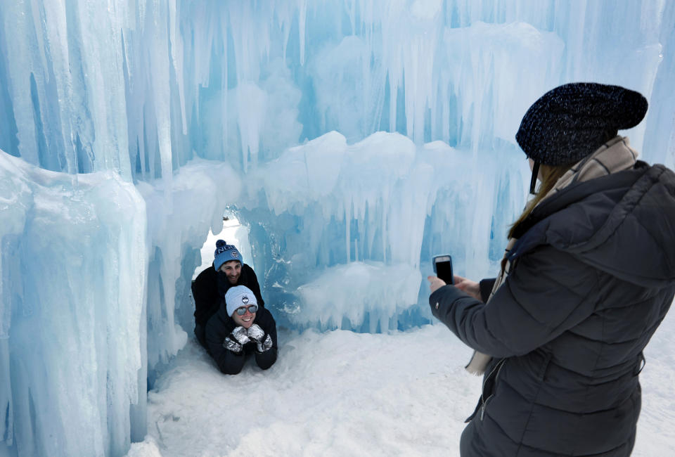 Visitors pose for a photo in a tunnel at Ice Castles in North Woodstock, N.H. With a seemingly endless variety of photo-ops, most visitors have a hard time putting their cameras down. (Photo: Robert F. Bukaty/AP)