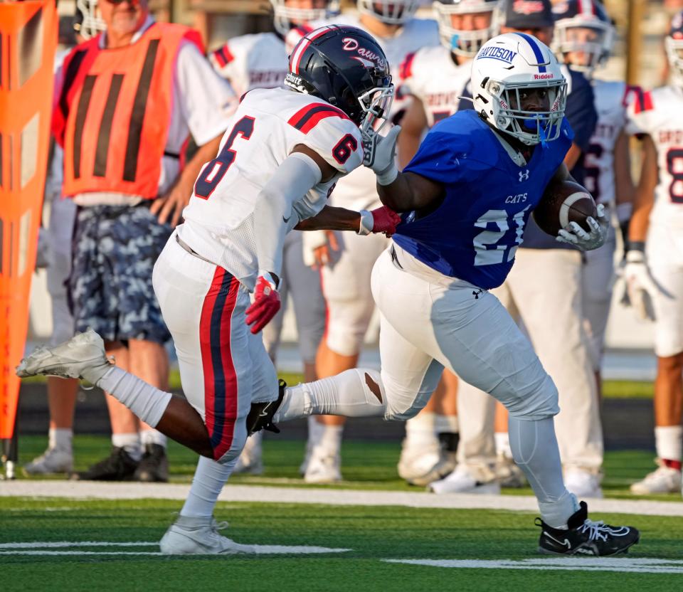 Aug. 25, 2023; Columbus, Oh., USA;  Davidson's Keevin Gibbon (21) runs the football while pursued by Ty Poole (6) of Grove City during Friday night's football game at Hilliard Davidson High School.