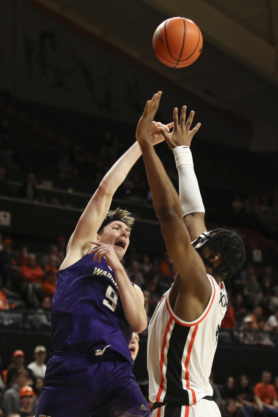 Washington guard Paul Mulcahy (9) shoots over Oregon State guard Dexter Akanno during the second half of an NCAA college basketball game Saturday, Feb. 10, 2024, in Corvallis, Ore. (AP Photo/Amanda Loman)