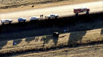 Emergency responders investigate the scene of a crash, Thursday, Feb. 22, 2024 on U.S. 287 about 10 miles (16 kilometers) south of the Wyoming-Colorado line between Laramie and Fort Collins, Colo. Three members of the University of Wyoming swimming and diving team were killed in the crash. (KMGH Denver7 via AP)