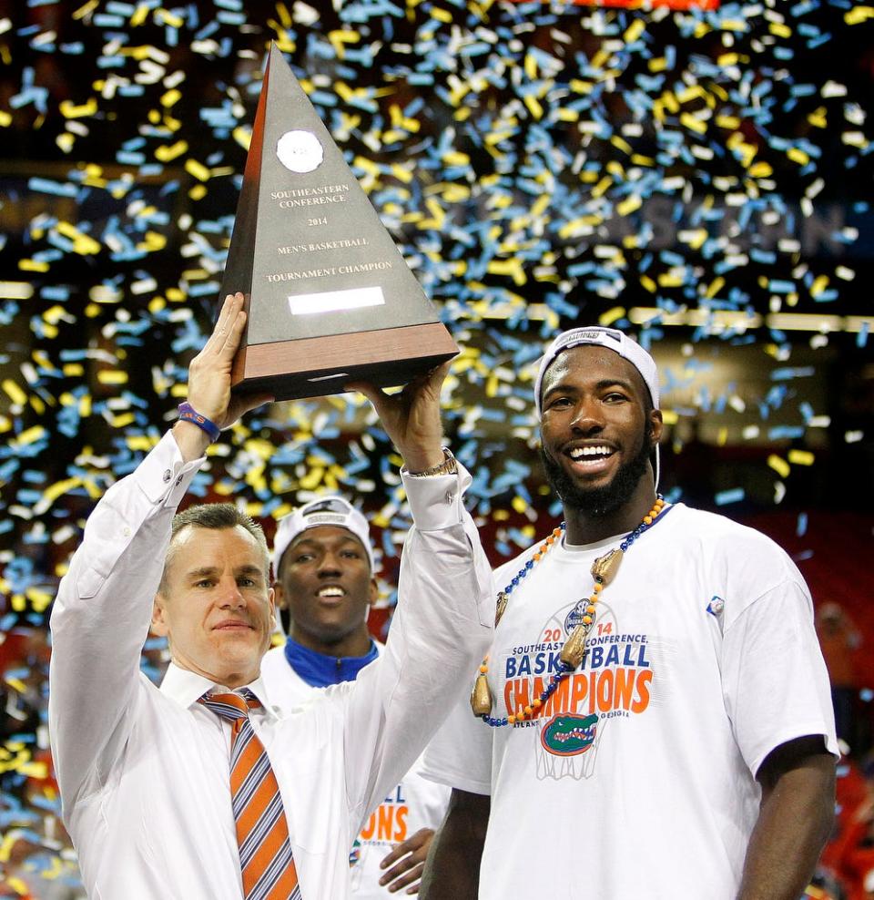 Florida Gators head coach Billy Donovan holds up the trophy next to Patric Young after defeating Kentucky 61-60 to win the SEC Tournament championship on Sunday, March 16, 2014 in Atlanta, Ga.