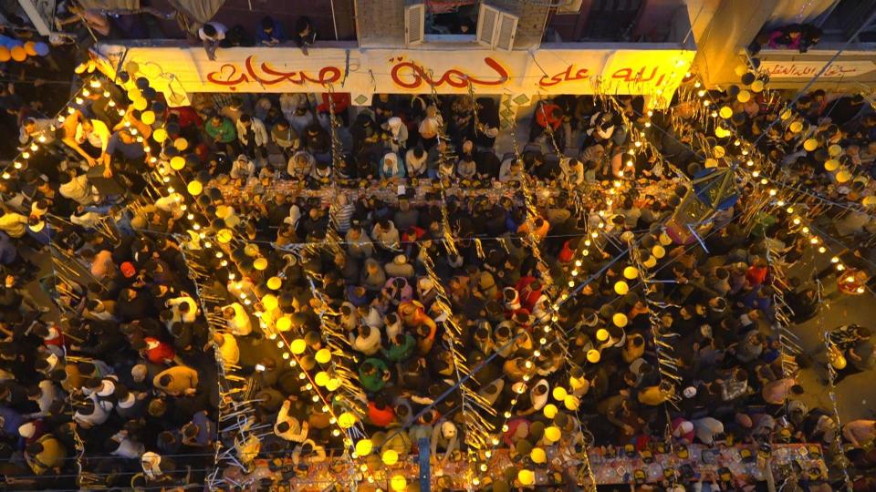 People pack a crowded street in northern Cairo's Matareya neighborhood for an annual mega-Iftar on the 15th day of Ramadan, March 25, 2024, in Egypt. / Credit: CBS News/Ahmed Shawkat