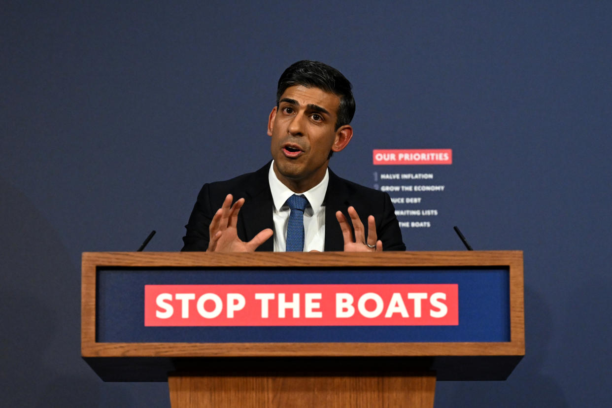 U.K. Prime Minister Rishi Sunak speaks at a lectern emblazoned with the words: Stop the Boats.