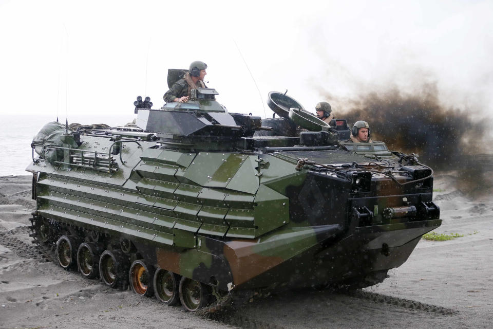 FILE - U.S. Marines from the 3rd Marine Expeditionary Brigade ride on their Amphibious Assault Vehicle (AAV) during the joint US-Philippines amphibious landing exercise Friday Oct.7, 2016 at Naval Education Training Command in San Antonio northwest of Manila, Philippines. A training accident off the coast of Southern California in an AAV similar to this one has taken the life of one Marine, injured two others and left eight missing Thursday, July 30, 2020. In a Friday morning tweet, the Marines say the accident happened Thursday and search and rescue efforts are underway with support from the Navy and Coast Guard. (AP Photo/Bullit Marquez, File)