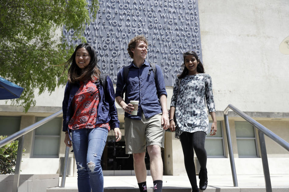 University of California students, from left, Alice Ma,Tyler Heintz and Anjali Banerjee walk near the university's campus Wednesday, June 6, 2018, in, Berkeley, Calif. The students who were in Nice, France when a terrorist drove a truck down a promenade killing 83 people, including one of their classmates, have channeled their grief and anger into two nonprofits to fight terrorism. (AP Photo/Marcio Jose Sanchez)