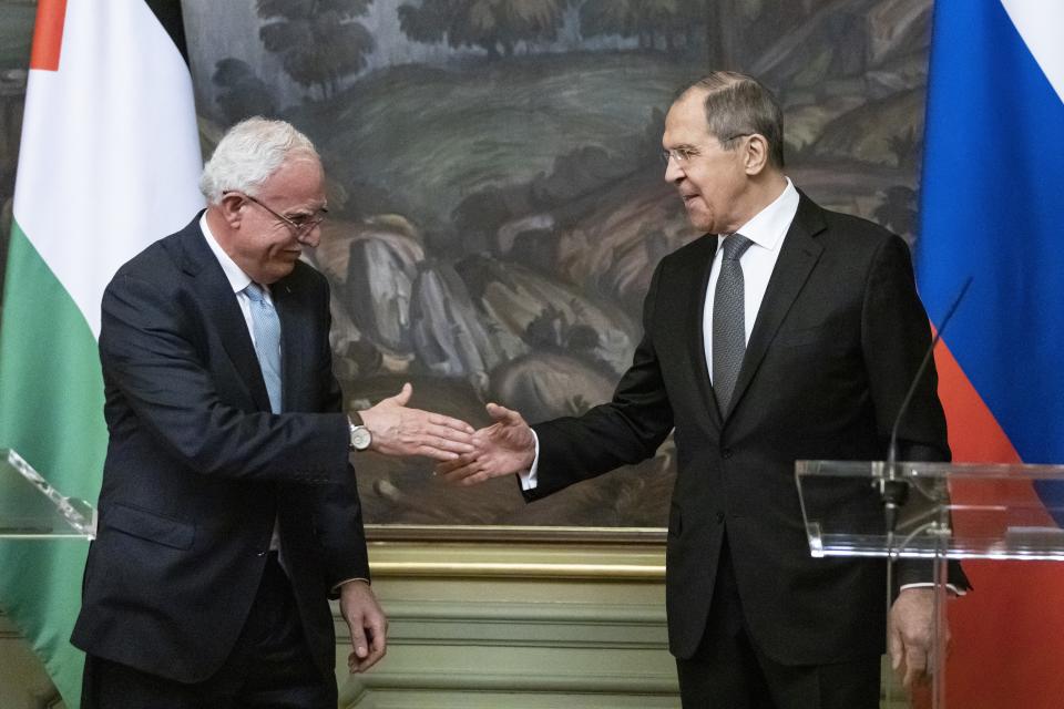 Russian Foreign Minister Sergey Lavrov, right, and Palestinian Foreign Minister Riyad Al-Maliki shake hands as they leave a joint news conference following their talks in Moscow, Russia, Wednesday, May 5, 2021. (AP Photo/Alexander Zemlianichenko, Pool)