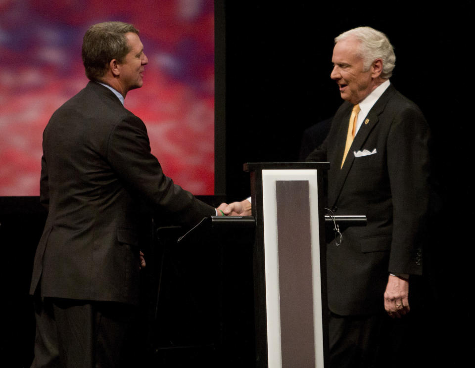 Democratic state Rep. James Smith and Republican Gov. Henry McMaster shake hands prior to the South Carolina governor debate, Wednesday, Oct. 17, 2018 at Francis Marion University Performing Arts Center in Florence, S.C. (Andrew J. Whitaker/The Post And Courier via AP)