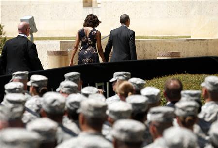 U.S. President Barack Obama and first lady Michelle Obama depart a memorial service in Fort Hood, Texas April 9, 2014. REUTERS/Kevin Lamarque