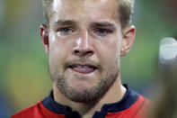 <p>Tom Mitchell of Britain reacts with tears in his eyes following a loss to Fiji in the gold medal match of the mens rugby sevens at the 2016 Summer Olympics in Rio de Janeiro, Brazil, Thursday, Aug. 11, 2016. (AP Photo/Robert F. Bukaty) </p>