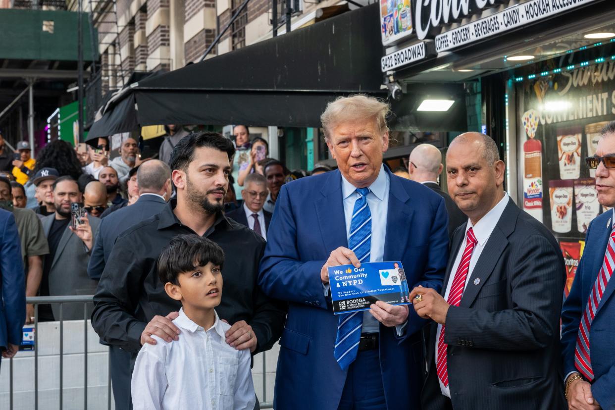 Former president Donald Trump stands with local politicians and bodega workers as he visits a bodega store in upper Manhattan where a worker was assaulted by a man in 2022 and ended up killing him in an ensuing fight on April 16, 2024 in New York City. The worker, Jose Alba, was arrested before the Manhattan District Attorney decided to drop charges for lack of evidence. Trump visited the bodega after spending a second day in court where he faces 34 felony counts of falsifying business records in the first of his criminal cases to go to trial