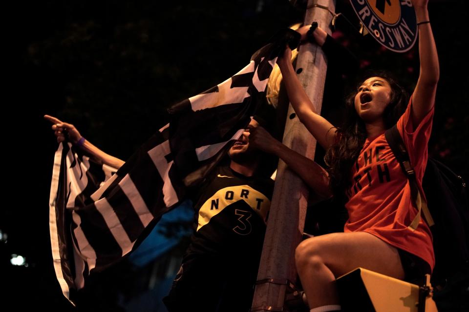 Toronto Raptors fans celebrate their win in the NBA championships in downtown Toronto, Ontario on early June 14, 2019. (Photo by Geoff Robins / AFP) (Photo credit should read GEOFF ROBINS/AFP/Getty Images)