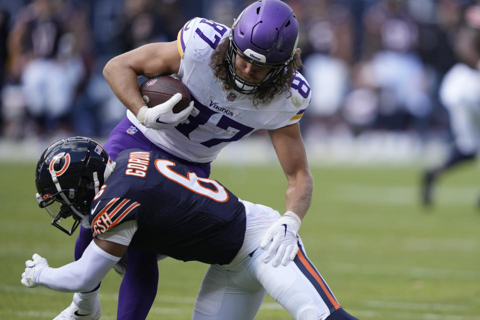 Minnesota Vikings tight end T.J. Hockenson (87) is tackled by Chicago Bears cornerback Kyler Gordon (6) during the second half of an NFL football game, Sunday, Oct. 15, 2023, in Chicago. (AP Photo/Charles Rex Arbogast)